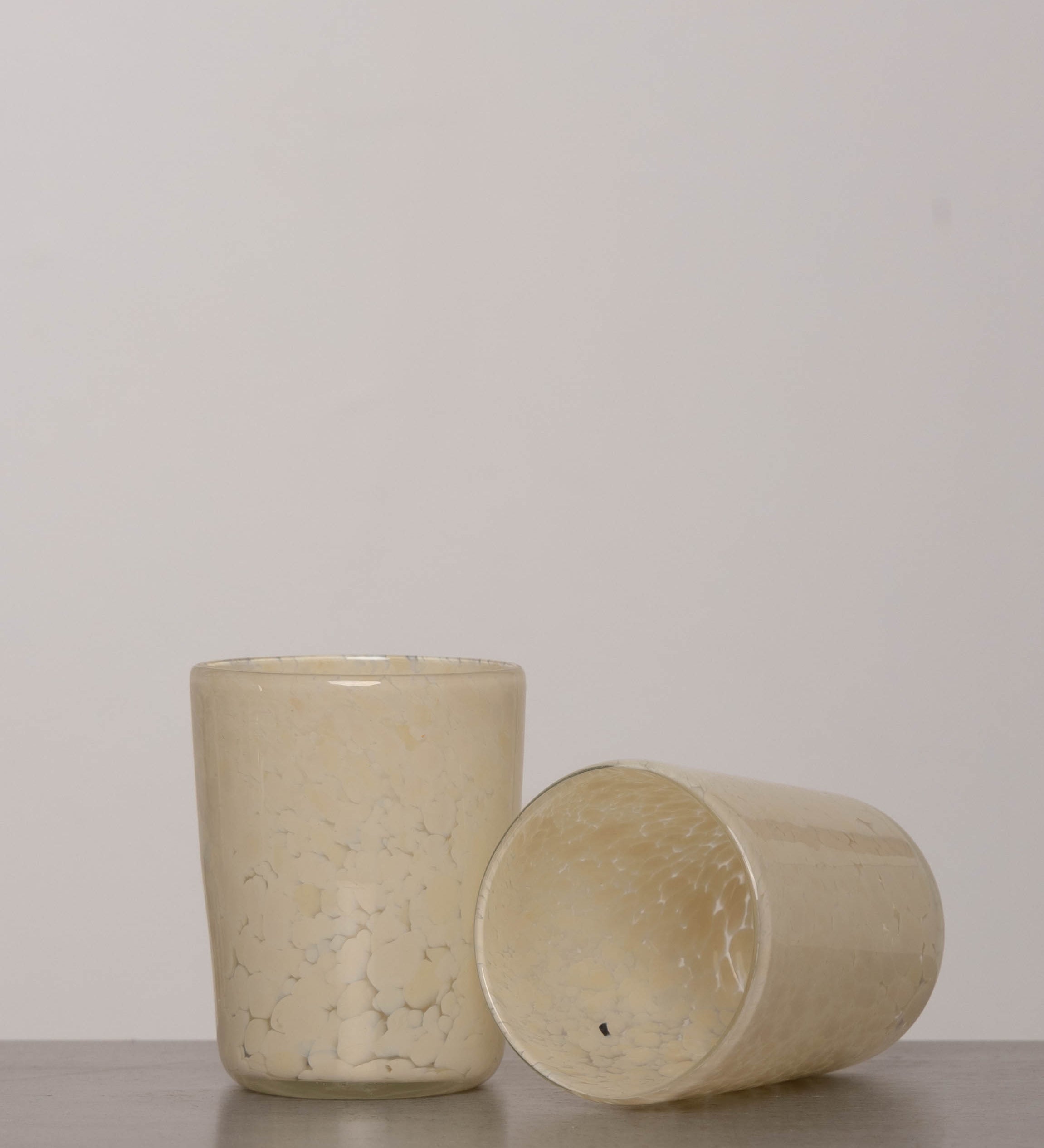 Discover the YAKUSH Blur Glass – a 4.7" tall, 3.5" wide handcrafted drinking glass made from recycled eco-friendly materials, perfect for water or cocktails.