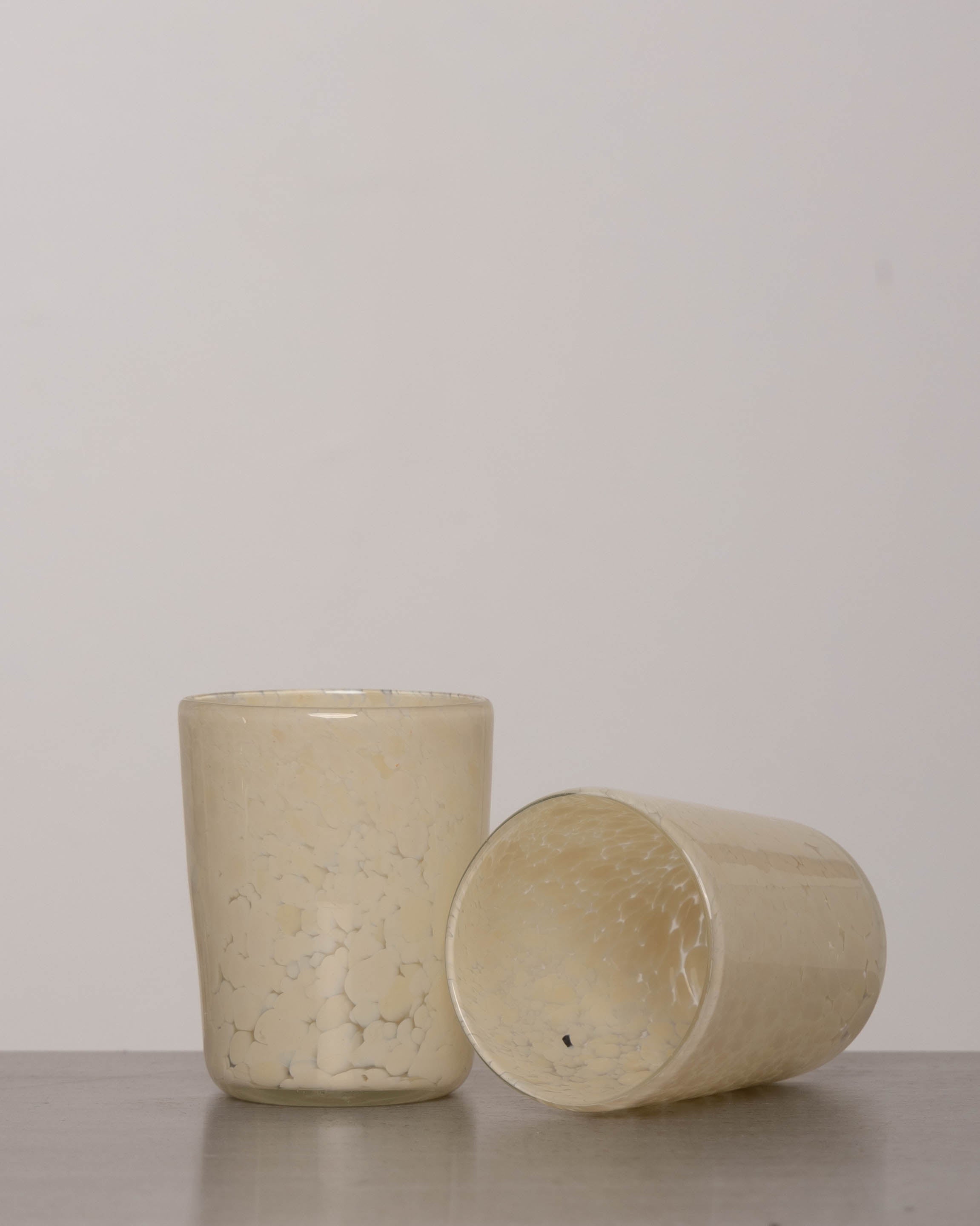 Discover the YAKUSH Blur Glass – a 4.7" tall, 3.5" wide handcrafted drinking glass made from recycled eco-friendly materials, perfect for water or cocktails.