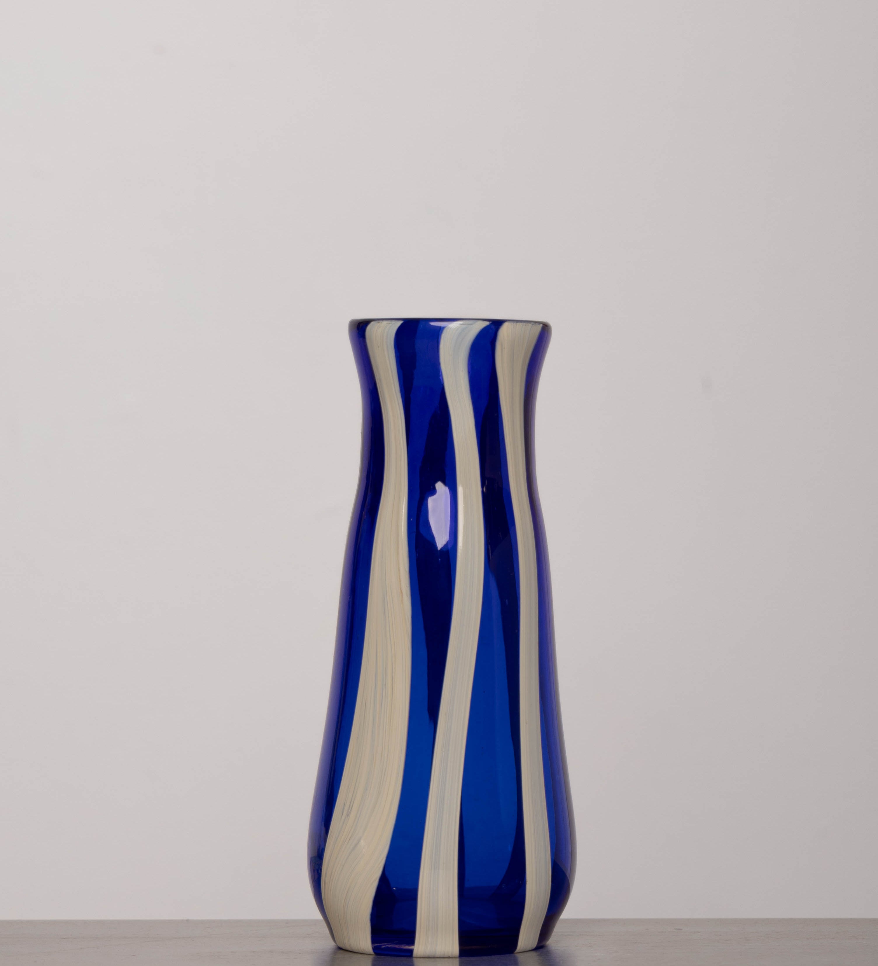 Discover the YAKUSH STRIPS Vase Blue – an 8.6" tall cornflower blue striped vase handmade from recycled glass, perfect for drinks or fresh flowers.