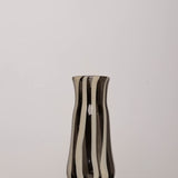 Discover the YAKUSH STRIPS Vase B&W – a 8.6" tall, black-and-white striped handmade recycled glass vase or bottle, ideal for drinks or flowers.
