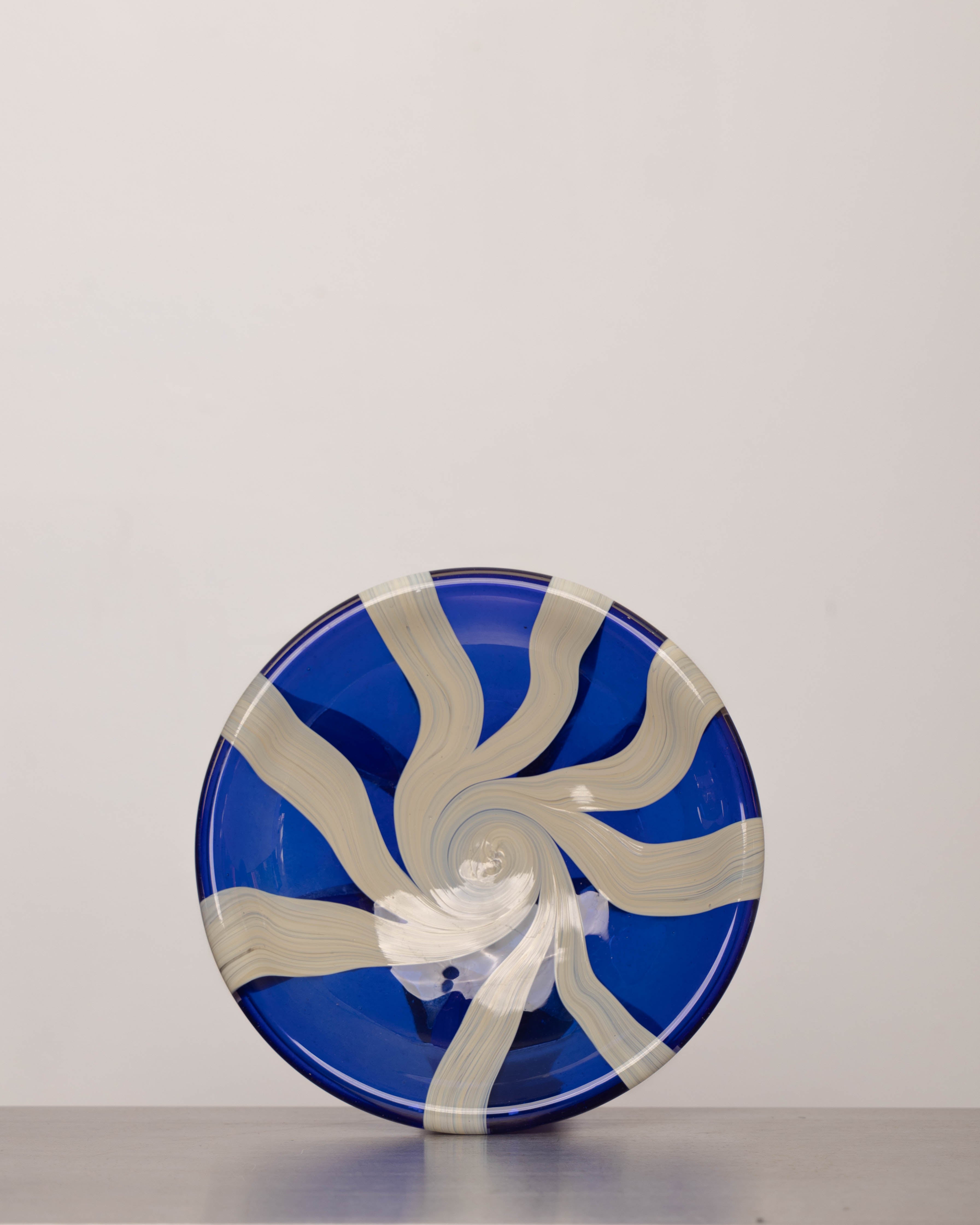 Discover the YAKUSH STRIPS Plate Blue – a 10.6" handcrafted double-walled plate made from recycled glass with bold cornflower blue stripes.