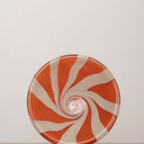 Discover the YAKUSH STRIPS Plate Orange – a 10.6" double-walled recycled glass plate with bold jam orange stripes, handcrafted by Ukrainian artisans.