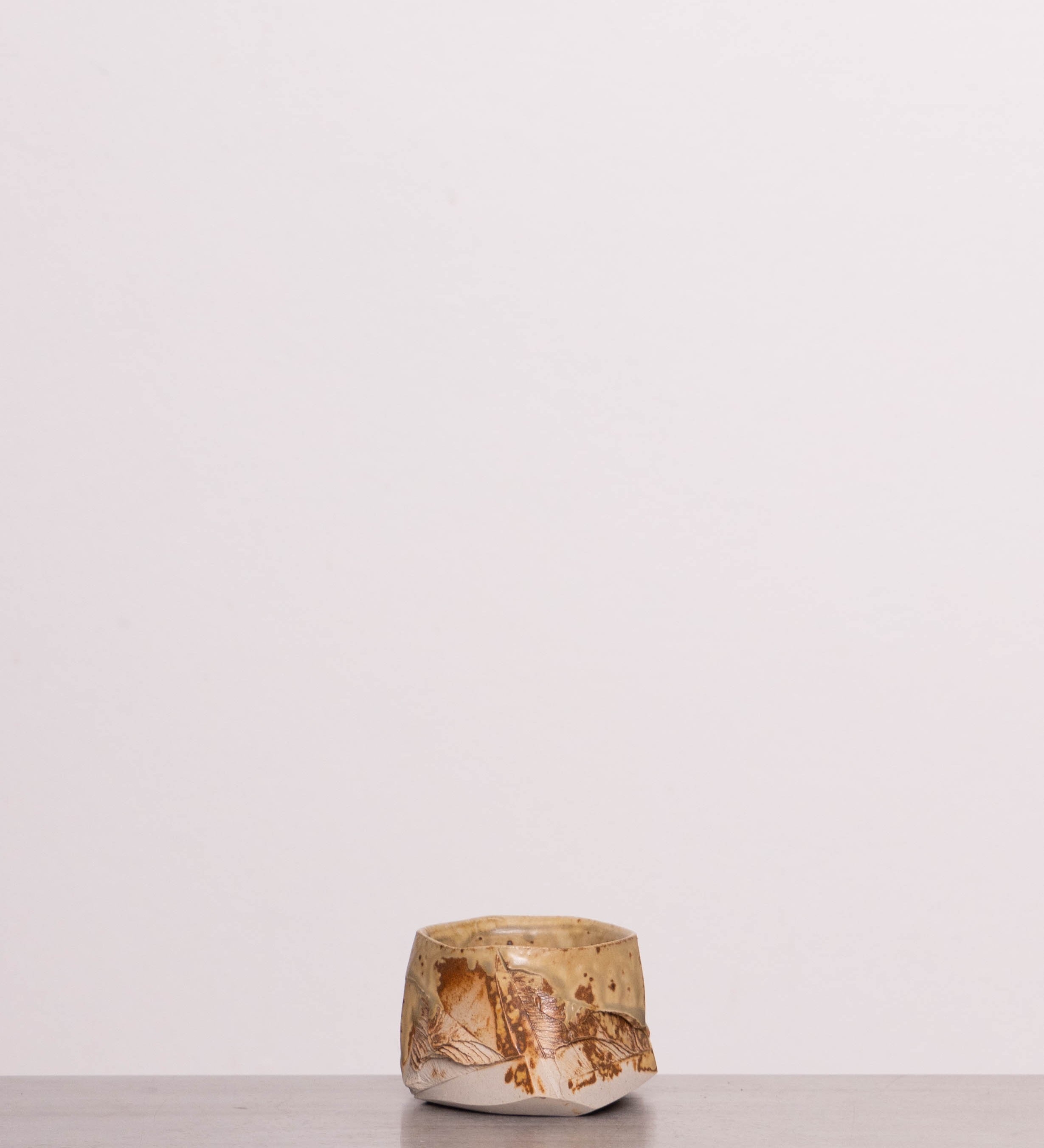 Discover the Pottery Park Discovery Bowl 3 – a handmade wabi-sabi ceramic espresso cup, crafted by Ukrainian artist Mikhail Tolstoy, featuring a faceted shape and unique texture.