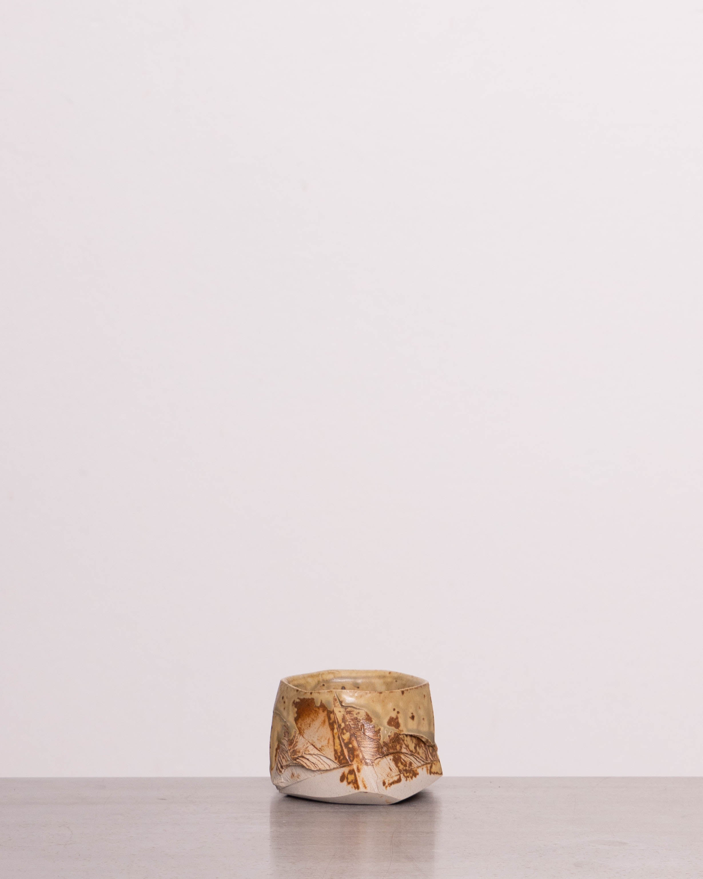 Discover the Pottery Park Discovery Bowl 3 – a handmade wabi-sabi ceramic espresso cup, crafted by Ukrainian artist Mikhail Tolstoy, featuring a faceted shape and unique texture.