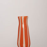 Discover the YAKUSH STRIPS Vase Orange – an 8.6" tall, jam orange striped recycled glass vase, handmade for drinks or floral displays.