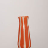 Discover the YAKUSH STRIPS Vase Orange – an 8.6" tall, jam orange striped recycled glass vase, handmade for drinks or floral displays.