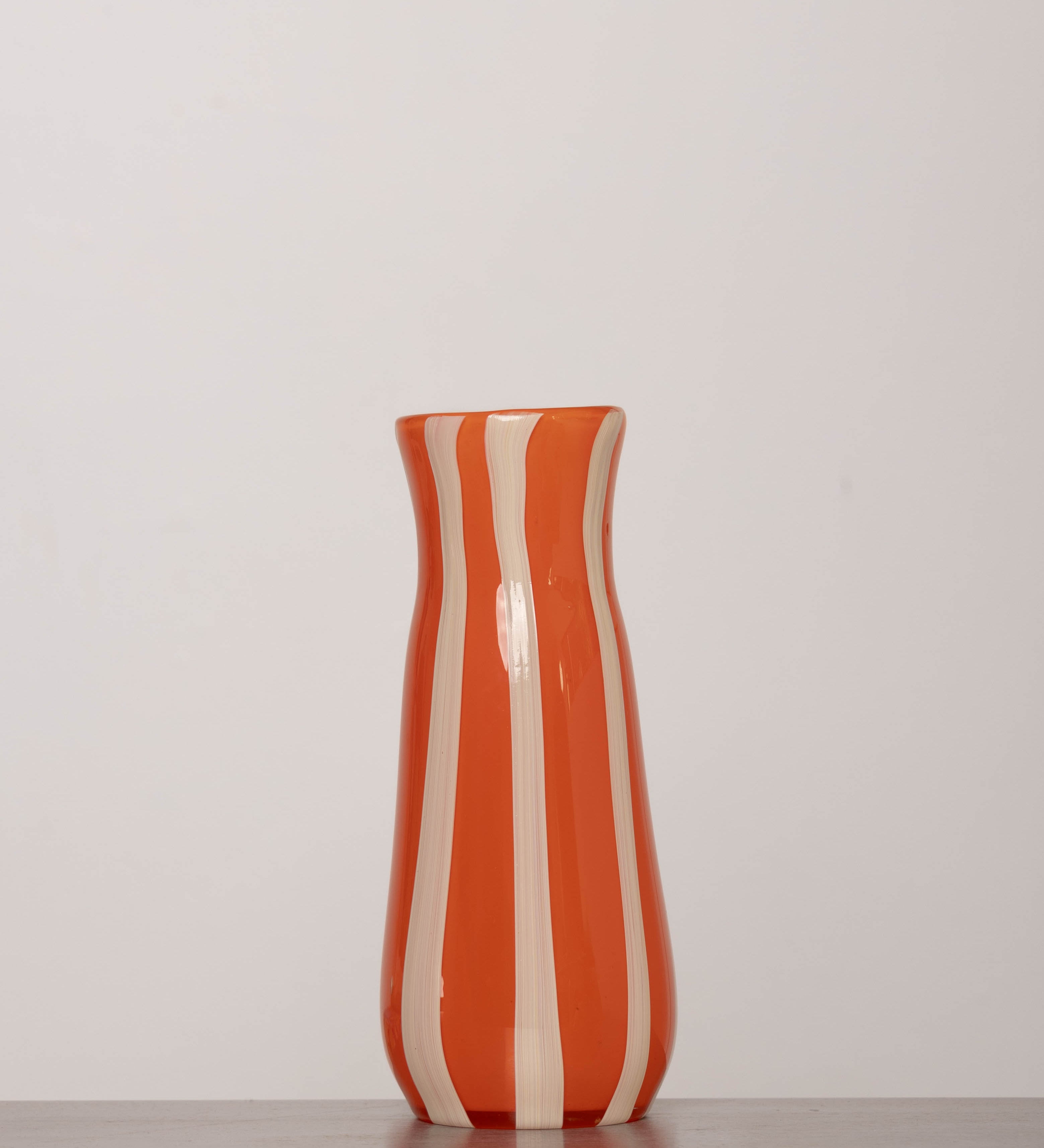 Discover the YAKUSH STRIPS Vase Orange – an 8.6" tall, jam orange striped recycled glass vase, handmade for drinks or floral displays.