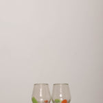 Discover the YAKUSH Tulip Glass – a 3.9" tall, tulip-shaped recycled glass wine glass, handmade with unique color variations.