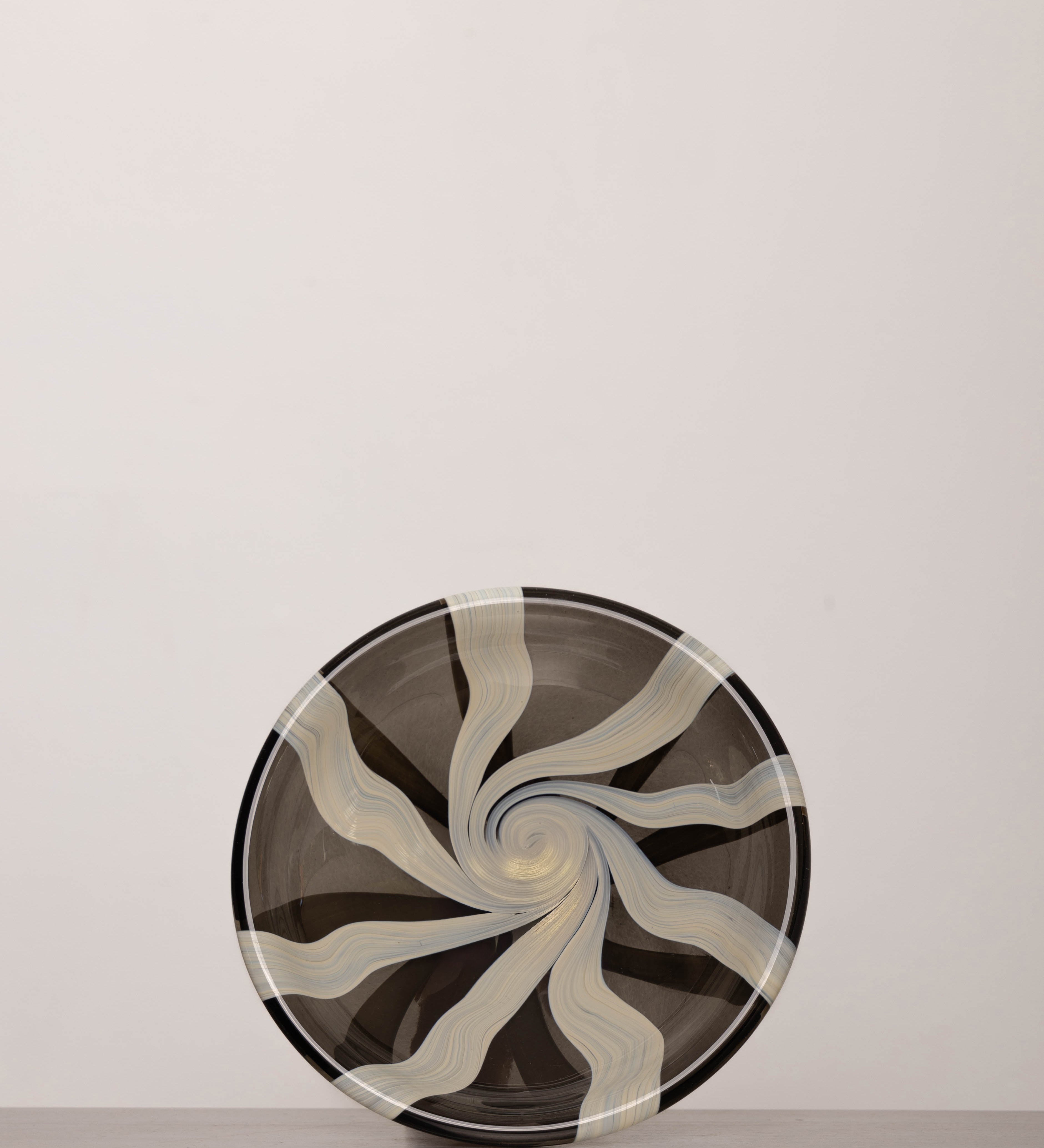 Discover the YAKUSH STRIPS Plate B&W – a 10.6" handcrafted black and white striped double-walled glass plate made from recycled glass.