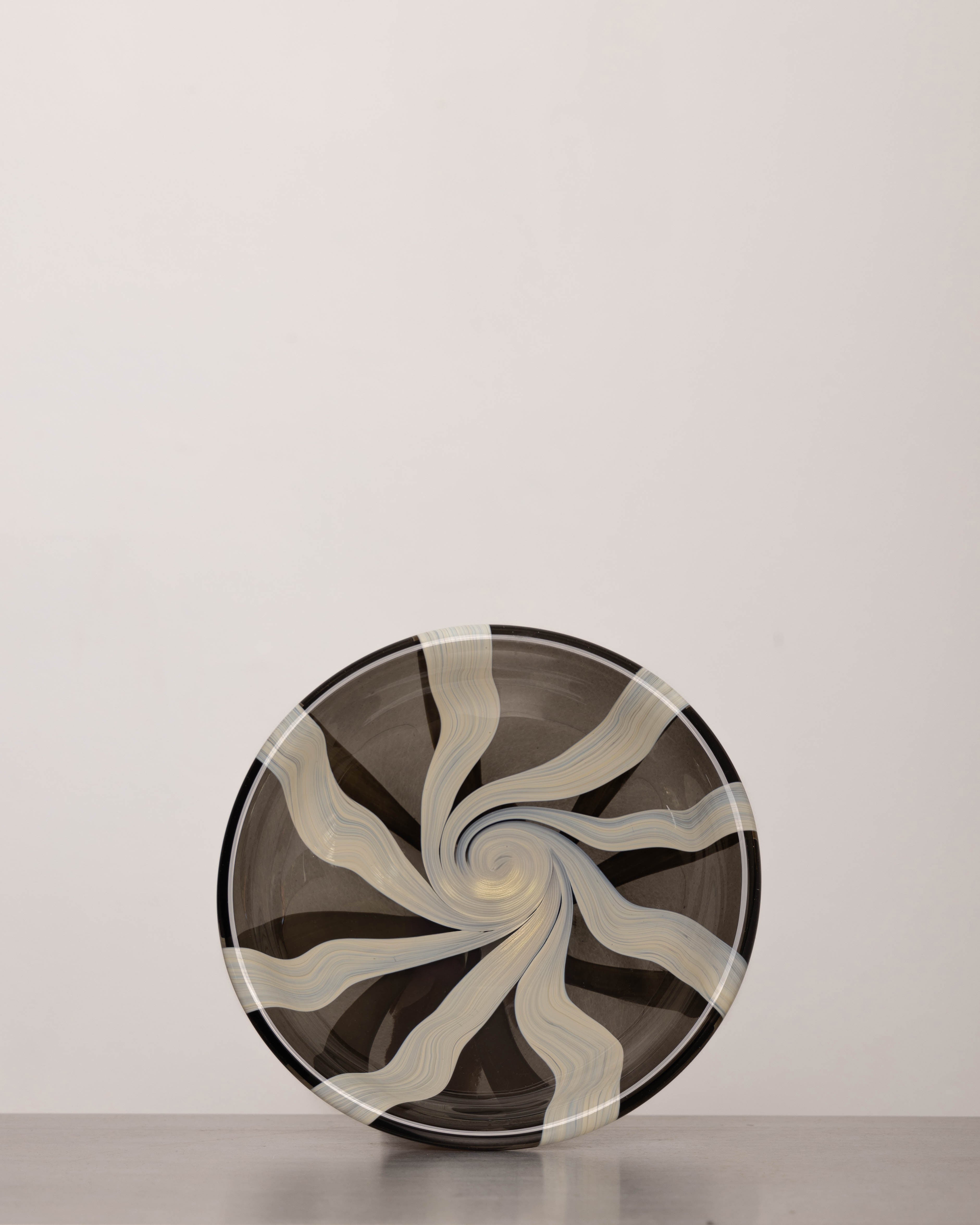 Discover the YAKUSH STRIPS Plate B&W – a 10.6" handcrafted black and white striped double-walled glass plate made from recycled glass.